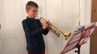 Child playing the trumpet - Your Space Music Lessons