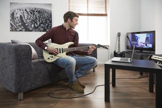 Man having an online guitar lesson with Your Space Music Lessons