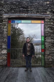 Ben Singer online piano teacher in front of a stained glass window