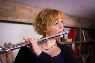 Lady playing the flute with online flute tutor at Your Space Music Lessons