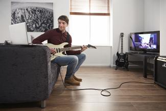 Man taking an online guitar lesson with Your Space Music Lessons