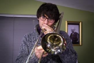 Man learning the trombone with Your Space Music Lessons